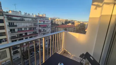 a balcony with a view of a city with buildings at Cosy 1 Bedroom, balcony, Promenade des Anglais in Nice