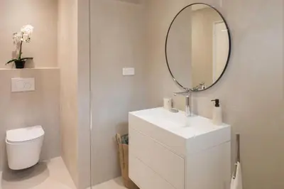 a bathroom with a white sink and a mirror at Satywizus #22- Duplex panoramic sea view 2Bdr, AC, swimpool, parking, petanque in Nice