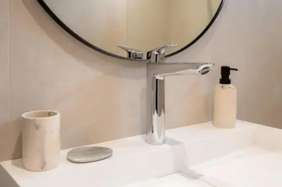 a bathroom sink with a faucet and a mirror at Satywizus #22- Duplex panoramic sea view 2Bdr, AC, swimpool, parking, petanque in Nice