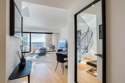 a living room with a mirror and a table and chairs at Satywizus #22- Duplex panoramic sea view 2Bdr, AC, swimpool, parking, petanque in Nice