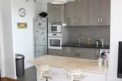 a kitchen with a counter and a refrigerator at 4 chambres, vue mer, calme in Nice