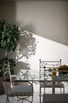a table and chairs with a tree stenciled on a wall at Vue exceptionnelle in Nice
