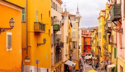 a street in an old town with yellow buildings at Sunny Old Town Studio in Nice