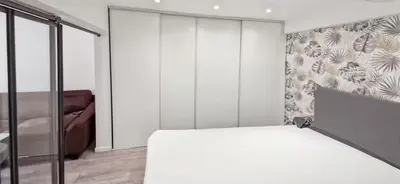 a bedroom with a bed and a sliding glass door at Sunny Old Town Studio in Nice
