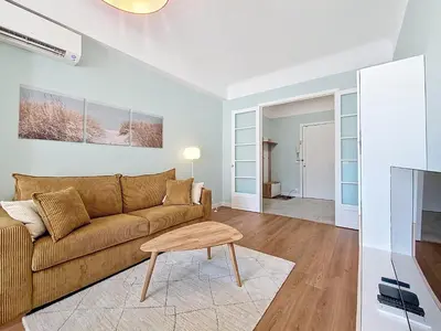 a living room with a brown couch and a table at Nestor&Jeeves - BLUE PASTEL PROMENADE - Spacious - Close sea in Nice