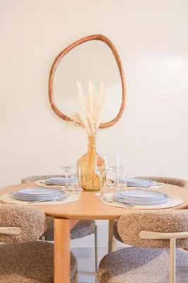 a table with glasses and a mirror on top of it at Superbe T3 tout confort à deux pas du tram et des plages in Nice