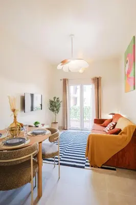 a bedroom with a bed and a table and a dining room at Superbe T3 tout confort à deux pas du tram et des plages in Nice