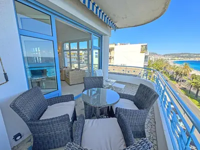 a balcony with chairs and a table on a building at Panoramic Sea front Cote d Azur in Nice