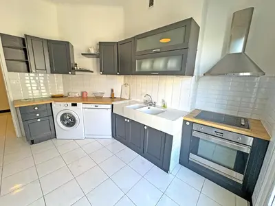 a kitchen with a sink and a washing machine at Panoramic Sea front Cote d Azur in Nice