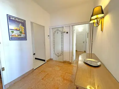 a living room with a table and a hallway at Panoramic Sea front Cote d Azur in Nice