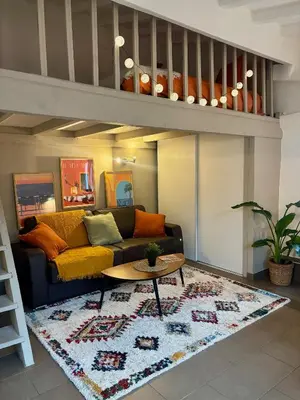 a living room with a couch and a table at Le Saint François - Au cœur du Vieux Nice in Nice