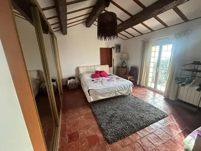 a bedroom with a bed with red pillows on it at Maison de charme piscine vue mer in Èze