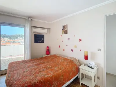 a bedroom with a large bed and a window at Penthouse d'exception avec terrasse panoramique in Nice