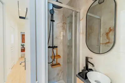 a bathroom with a sink and a mirror at Splendide Appartement Rénové Au Cœur du Vieux Nice in Nice