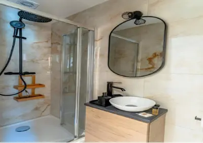 a bathroom with a sink and a shower and a mirror at Splendide Appartement Rénové Au Cœur du Vieux Nice in Nice