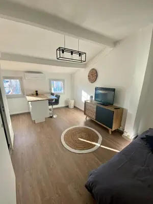 a living room with a bed and a desk at Studio moderne au Carré d'Or in Nice