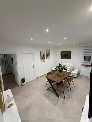 a living room with a table and a couch at Nice - 6 personnes - 3 lits - 3 pièces - Parking ! in Nice