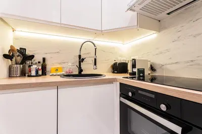 a kitchen with a sink and a stove at La Bellanda - Au coeur du Vieux Nice in Nice