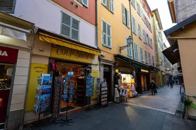 a street with shops and buildings in a city at La Bellanda - Au coeur du Vieux Nice in Nice