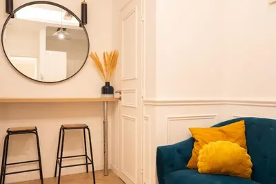 a blue couch in a room with a mirror at La Bellanda - Au coeur du Vieux Nice in Nice
