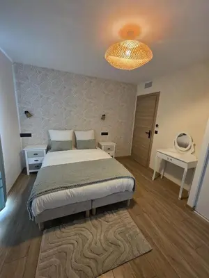 a bedroom with a large bed and a lamp at La costière in Nice