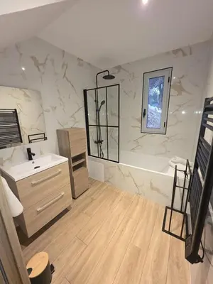 a bathroom with a sink and a bath tub at La costière in Nice