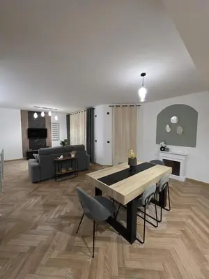 a living room with a table and a couch at La costière in Nice