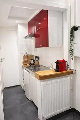 a kitchen with red cabinets and a counter top at DeLuxe Studio Cosy, Promenade des Anglais, NICE CENTRE in Nice
