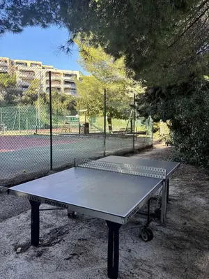 a ping pong table in front of a tennis court at Le Ciel de Fabron Piscine et Tennis in Nice