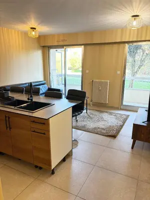 a kitchen with a sink and a living room at Le Ciel de Fabron Piscine et Tennis in Nice