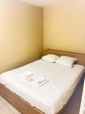 a bedroom with a bed with two towels on it at Le Ciel de Fabron Piscine et Tennis in Nice