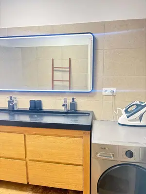 a bathroom with a sink and a washing machine at Le Ciel de Fabron Piscine et Tennis in Nice