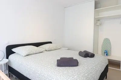 a kitchen and living room with a table and a couch at Nice Time - Chic Apartment with sunny terrace, Nice Port in Nice