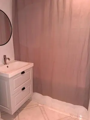 a bathroom with a sink and a shower curtain at Appartement 4 couchages Nice in Nice