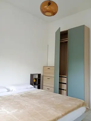 a bedroom with a bed and a closet at Artemare, il fascino del classico con ogni comfort in Nice