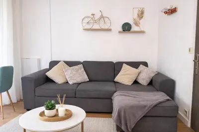 a living room with a couch and a table at Studio Carré Or avec balcon in Nice