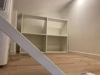an empty room with a staircase with white shelves at Studio Nice cosy et plein centre in Nice