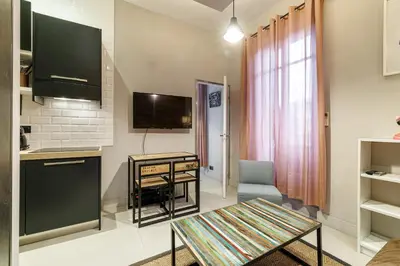 a living room with a couch and a brick wall at Charming 1 Bdr Downtown in Nice