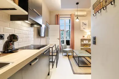 a kitchen with a counter and a dining room at Charming 1 Bdr Downtown in Nice