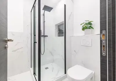a white bathroom with a shower and a toilet at Carre dOr Design Confort and Centralité in Nice