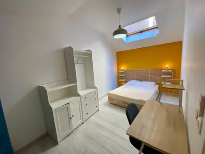 a bedroom with a bed and a desk and a table at T4 Nice Centre - Close to shops, Wi-Fi, AC in Nice