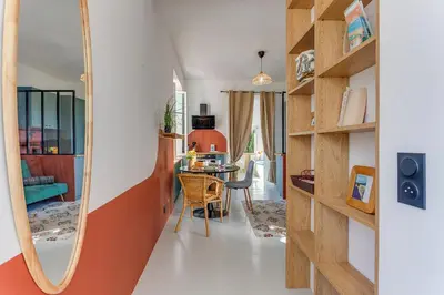 a living room with a mirror and a table at STUDIO AZUR AP4487 By Riviera Holiday Homes in Villefranche-sur-Mer