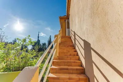 a stairway leading up to a building with a blue sky at STUDIO AZUR AP4487 By Riviera Holiday Homes in Villefranche-sur-Mer
