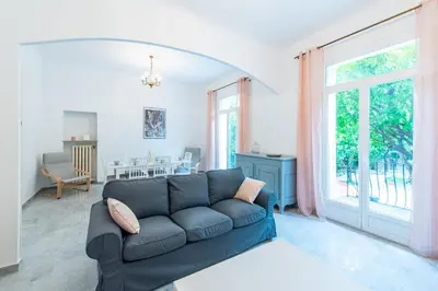 a living room with a couch and a window at Happyfew maison Michelet in Nice