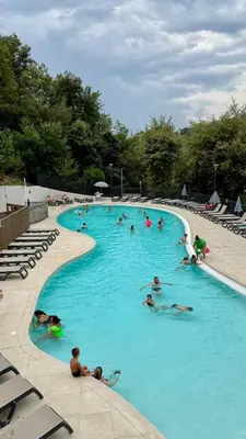 a group of people swimming in a swimming pool at Cosy mobil-home wifi clim in Cagnes-sur-Mer