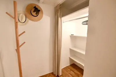 a hallway with a hat and shelves in a room at Charmant appartement au sein de la vieille ville in Villefranche-sur-Mer