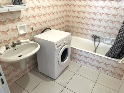 a kitchen with white cabinets and a stove top oven at Charming 2-room near beach with terrace in Cagnes-sur-Mer