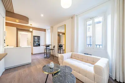 a living room with a couch and a table at Appartement cosy au coeur de Cagnes sur Mer in Cagnes-sur-Mer