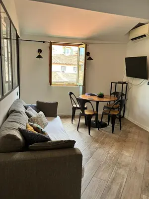 a living room with a couch and a table at Magnifique 2P Vieux Nice AC-WIFI in Nice