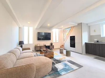 a large living room with a couch and a table at Elegant Renovated Apartment Nice Port AC Sleeps 4 in Nice